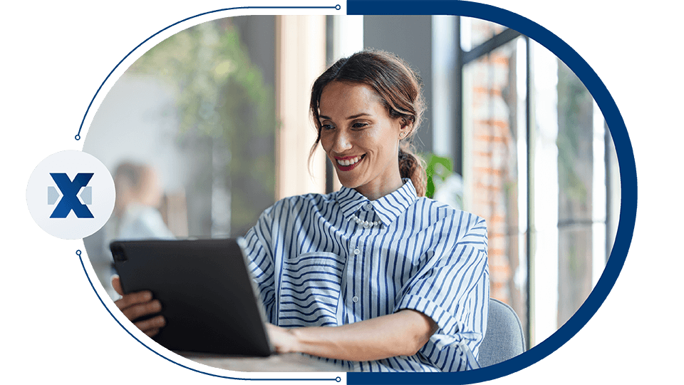 Woman in blue and white striped shirt working with a tablet.